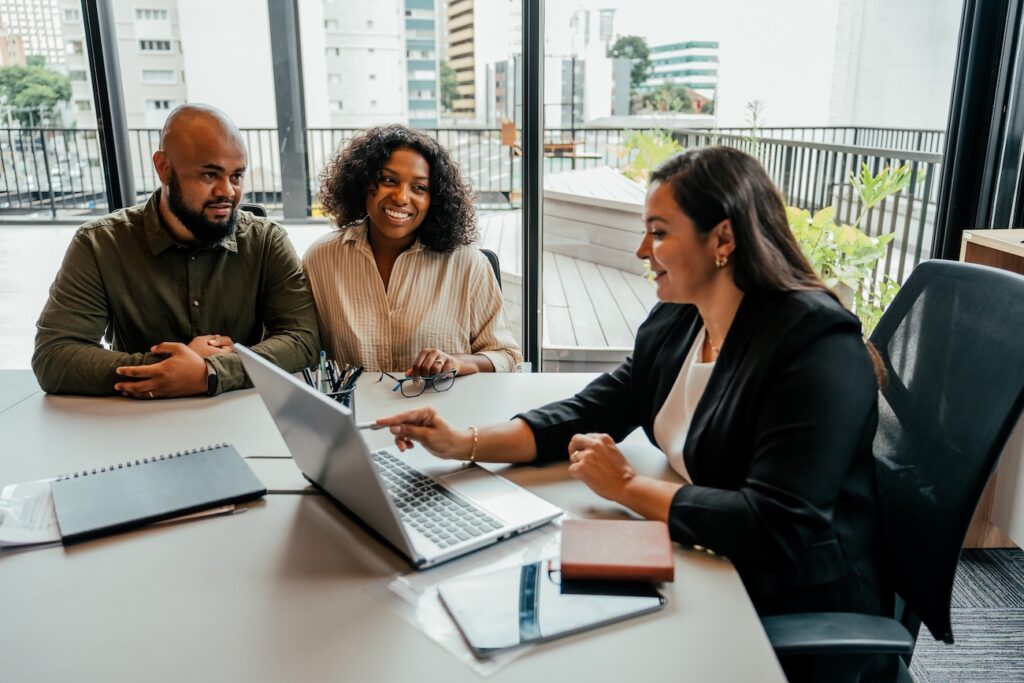Couple Talking to Real Estate Agent in Office