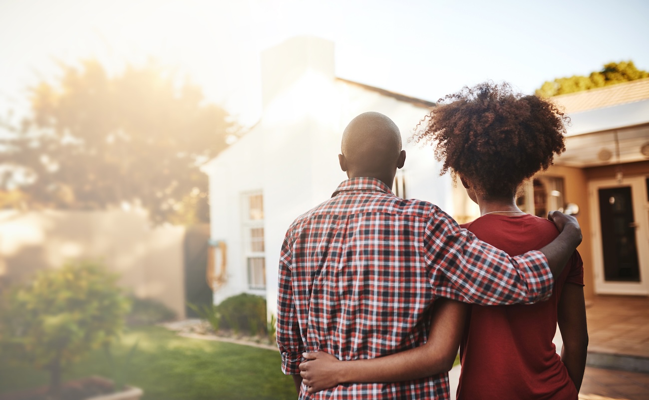 Young couple admiring their new house