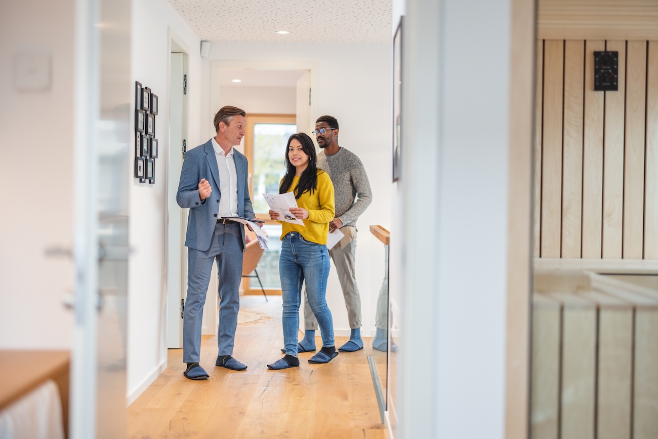 Agent with clients showing home